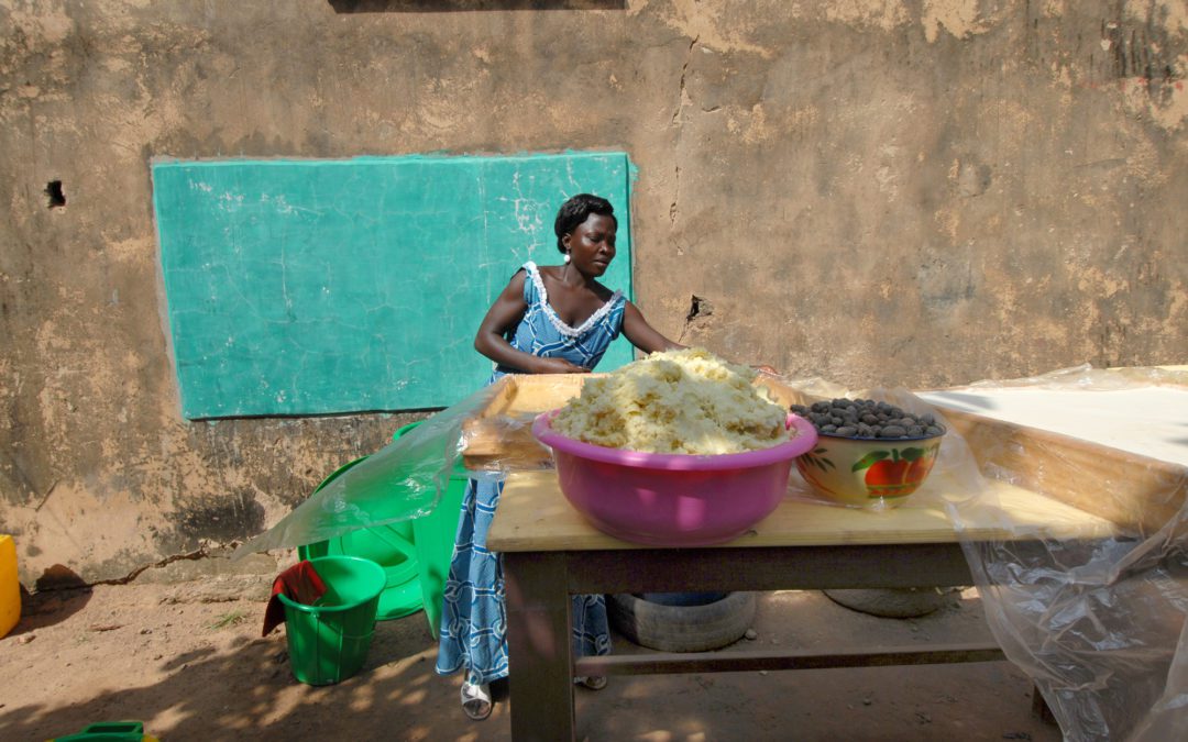 African woman making shea butter by hand